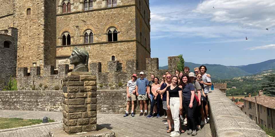 A group of students taking in the history and beautiful views of Italy.